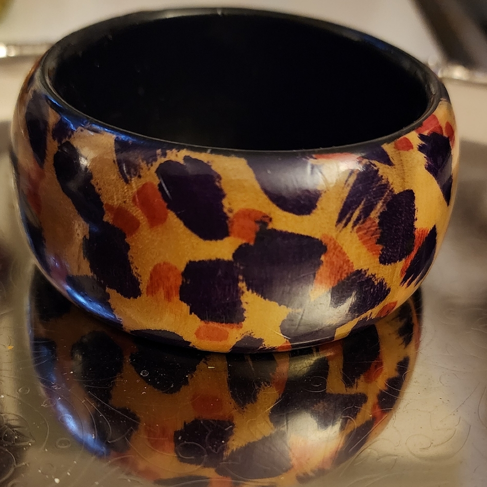 Handcrafted Wood Bangle featuring pink and purple leopard pattern.